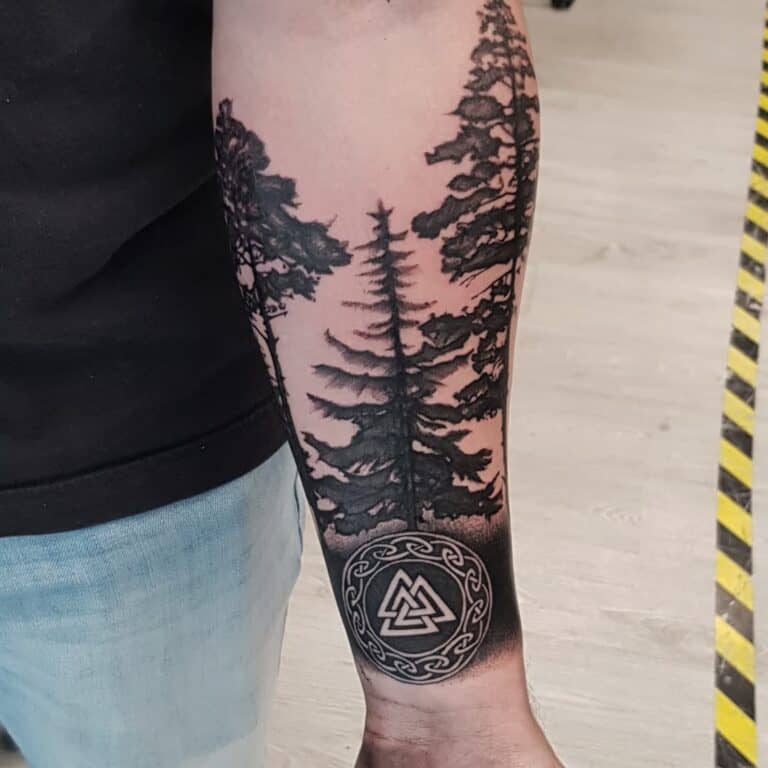 Black and grey tattoo met keltisch teken en bomen op onderarm, geplaatst bij Inksane tattoo en piercing
