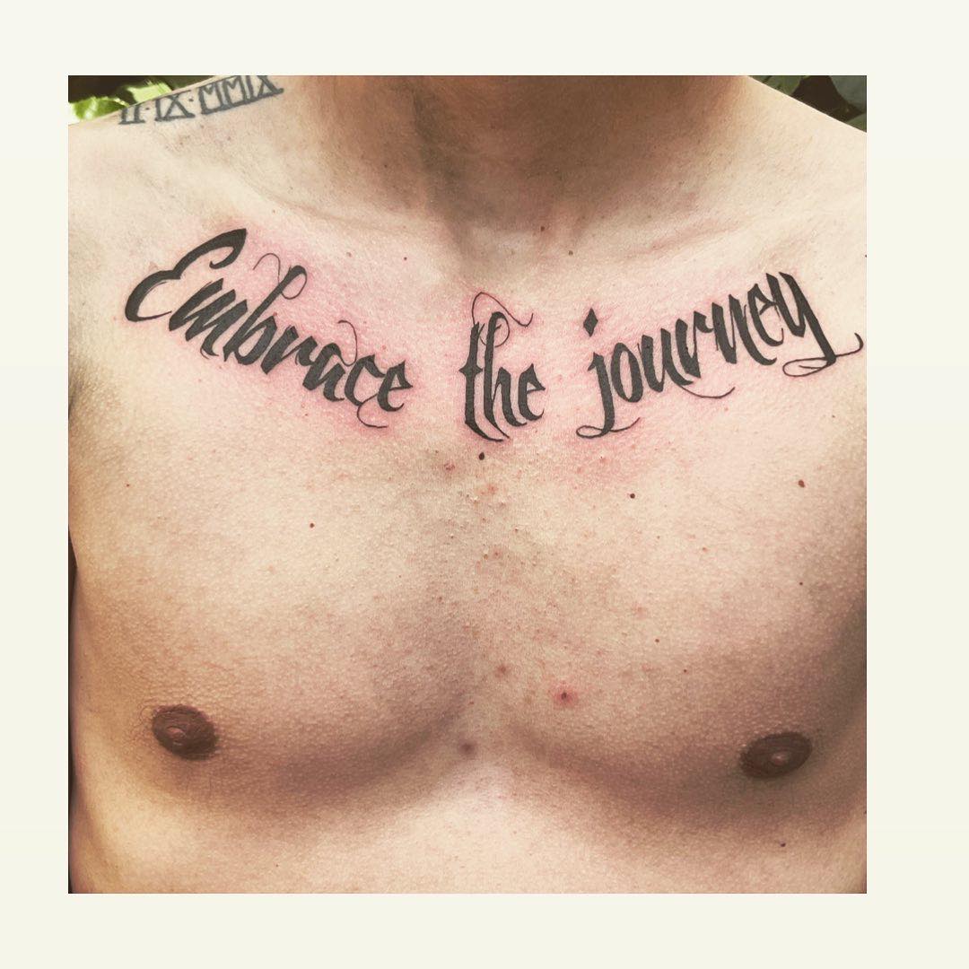 Thick script tattoo on the chest by Glenn