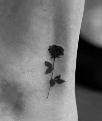 Small flower rose blackwork tattoo