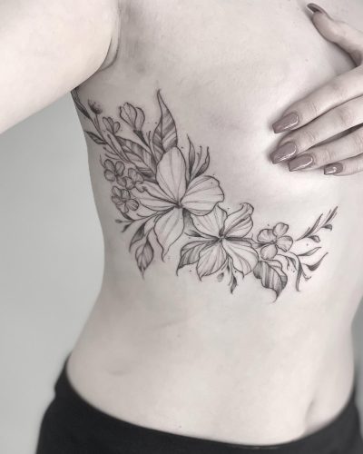 fine line flower tattoo under breast